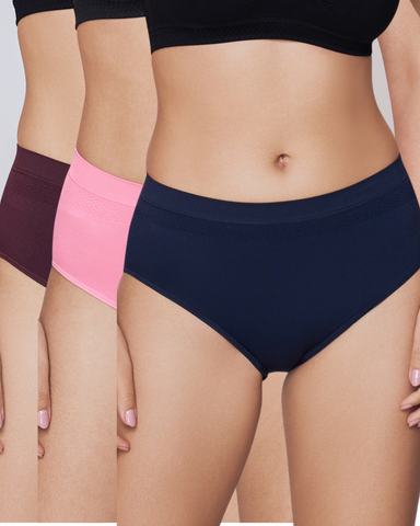 Three pairs of underwear in black, pink, and navy on a neutral background