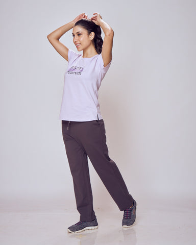 Woman posing in a white t-shirt and dark Classic Flex Regular Fit Track Pants on a plain background