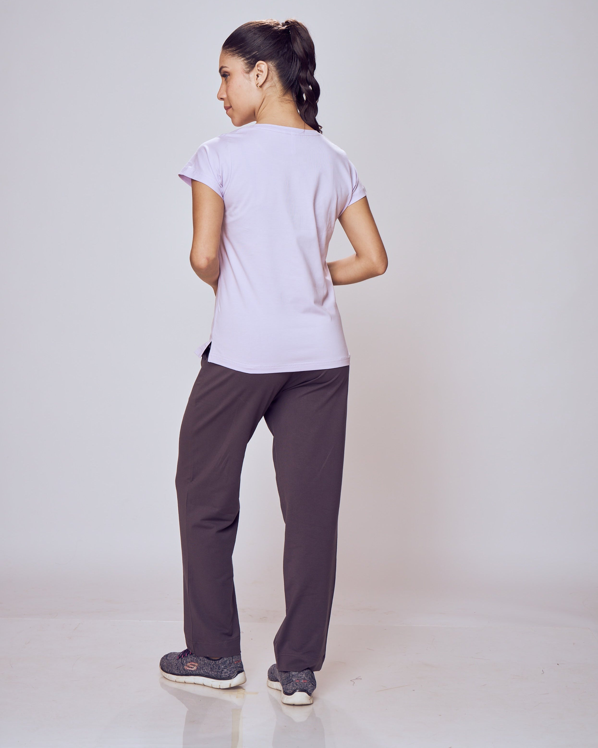 Person wearing a white shirt and dark Classic Flex Regular Fit Track Pants on a plain background