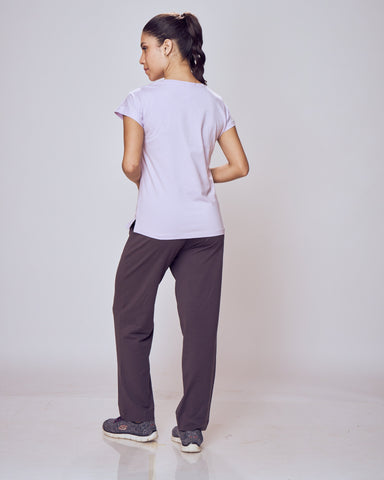 Person wearing a white shirt and dark Classic Flex Regular Fit Track Pants on a plain background