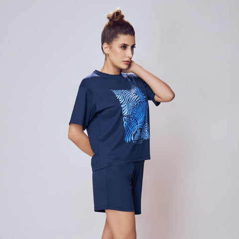 Person wearing a navy blue t-shirt and shorts set with a blue graphic design on a white background. Co-ord Set for Women