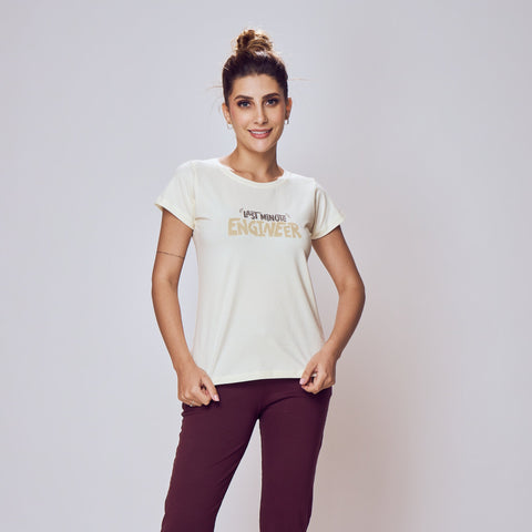 Woman wearing a white t-shirt and purple pants on a plain background