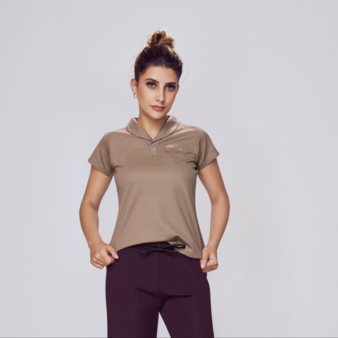 Woman wearing a brown top and purple pants on a white background