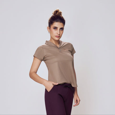 Woman wearing a beige top and purple pants on a white background