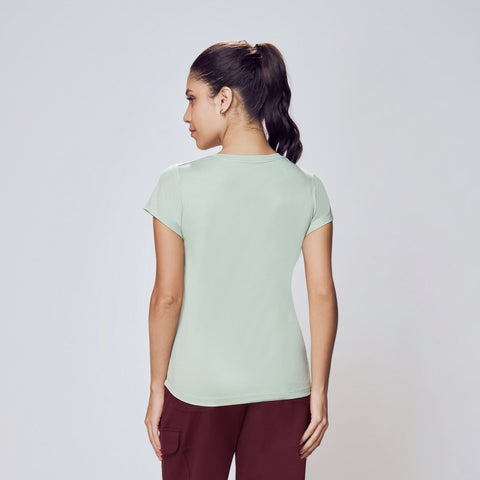 Person wearing a light green t-shirt and maroon pants on a white background