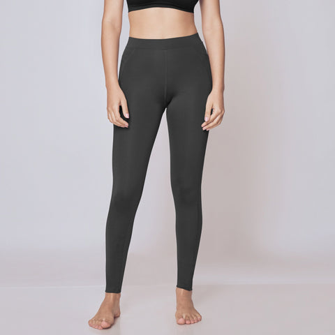 Woman wearing black sports bra and High-Rise Active Tights on a white background