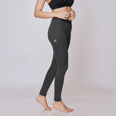 Woman wearing black athletic top and High-Rise Active Tights on a white background