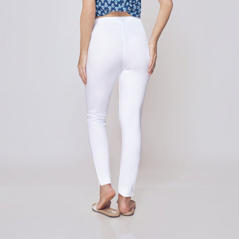 Woman wearing a blue patterned top and white Kurti Pants Leggings on a plain background