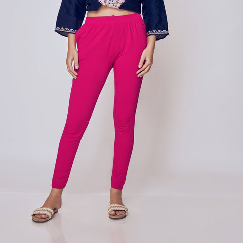 Woman wearing a navy blue embroidered top and pink Kurti Pants Leggings on a white background