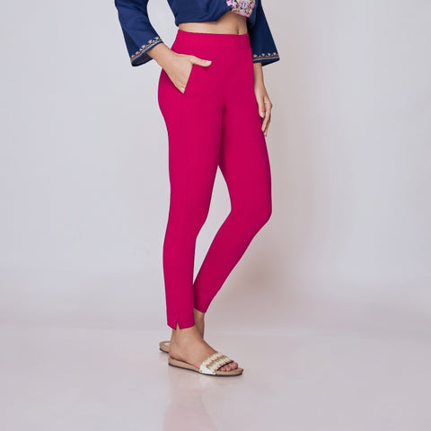 Woman wearing a blue embroidered top and pink Kurti Pants Leggings on a white background