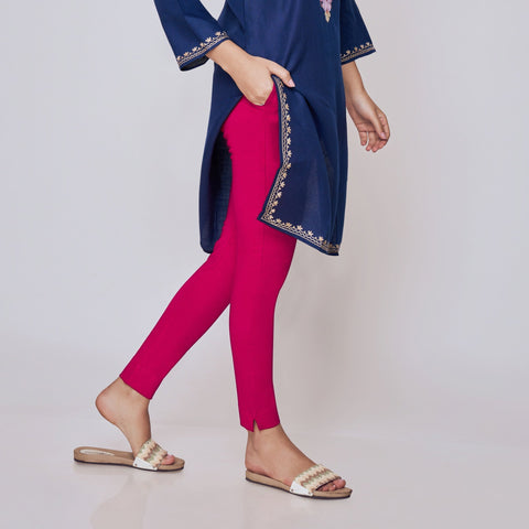 Woman wearing a navy blue embroidered top and pink Kurti Pants Leggings on a white background