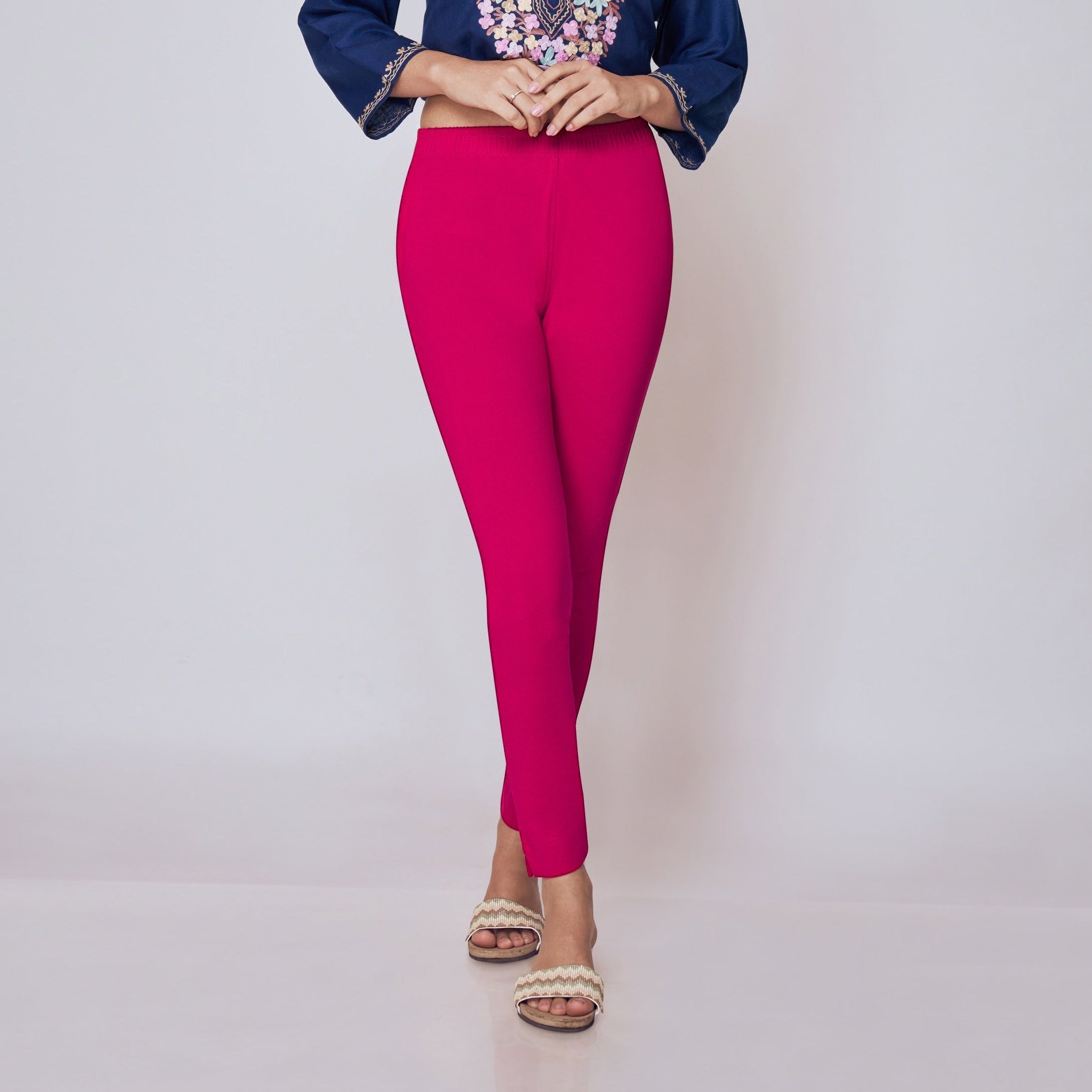 Woman wearing a blue embroidered top and pink Kurti Pants Leggings on a white background