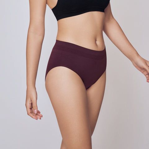 Woman wearing a black sports bra and maroon  Lady Care Air V Hipster Panty underwear on a light gray background