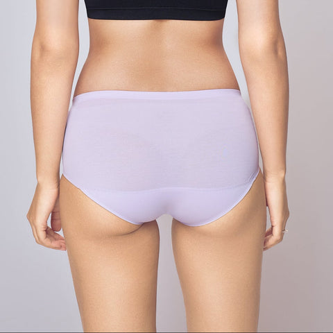 Woman wearing a black bra and light purple Lady Care think Panty on a gray background