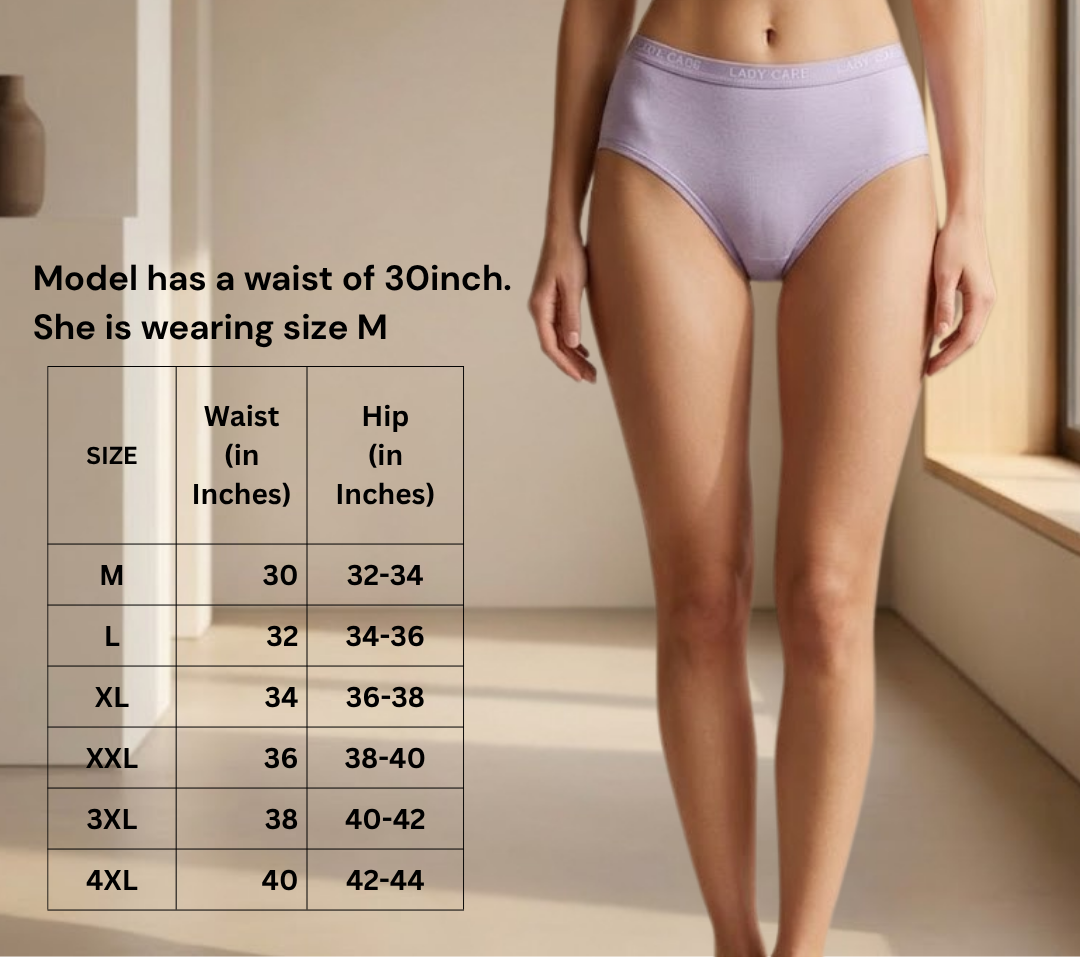 A woman modeling light lavender high-waisted briefs with a black bra, standing indoors next to a size chart that lists waist and hip measurements by size.